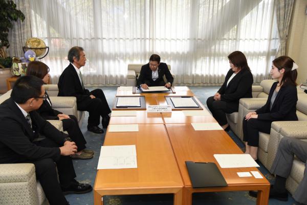 協定書にサインをしている画像